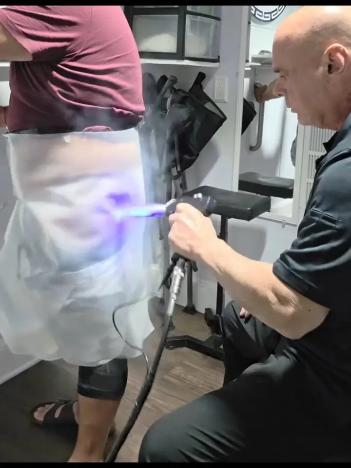 Gregory Papageorge performing a hip treatment